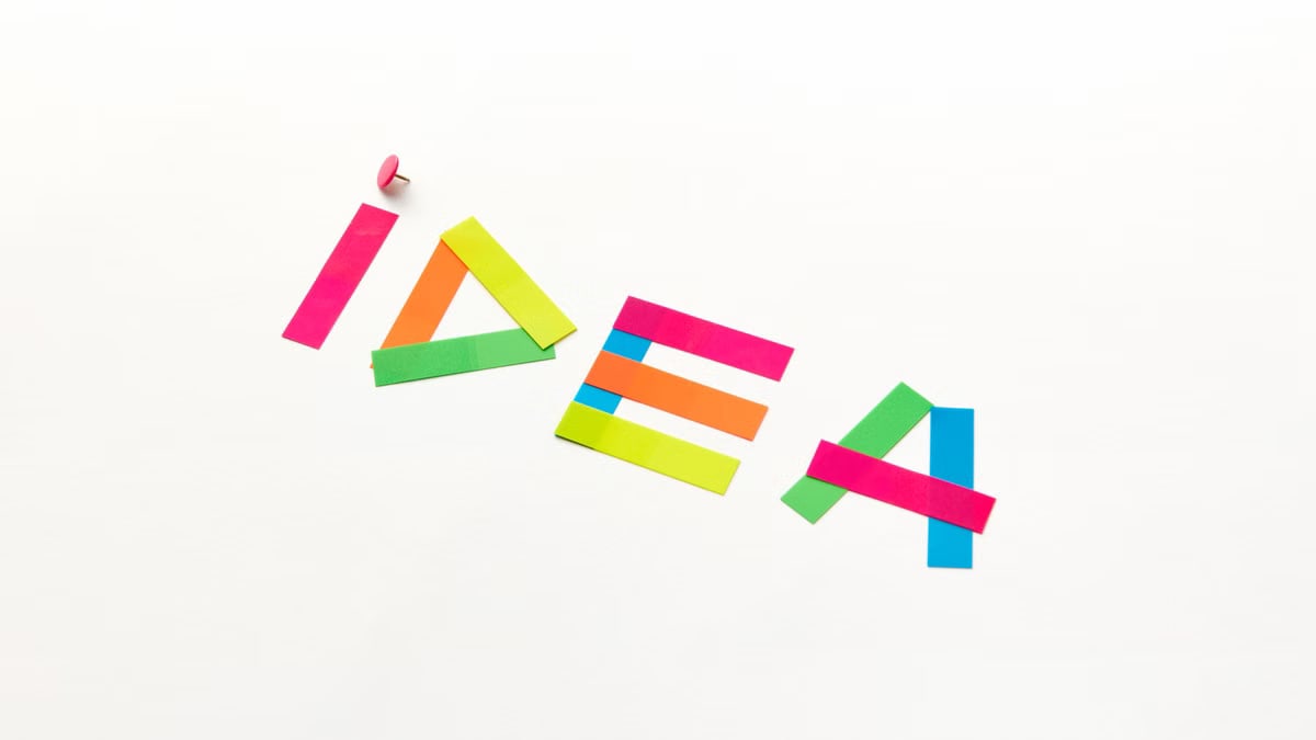 Creative concept with colorful paper cutouts spelling 'IDEA' against a white background.